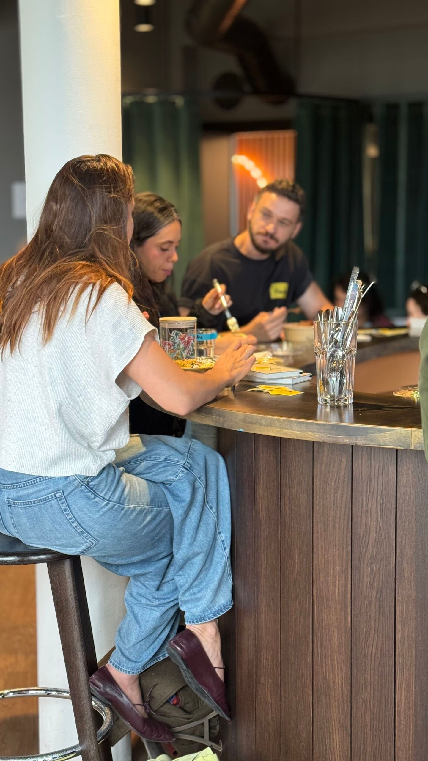 Attendees chatting over lunch at the bar counter